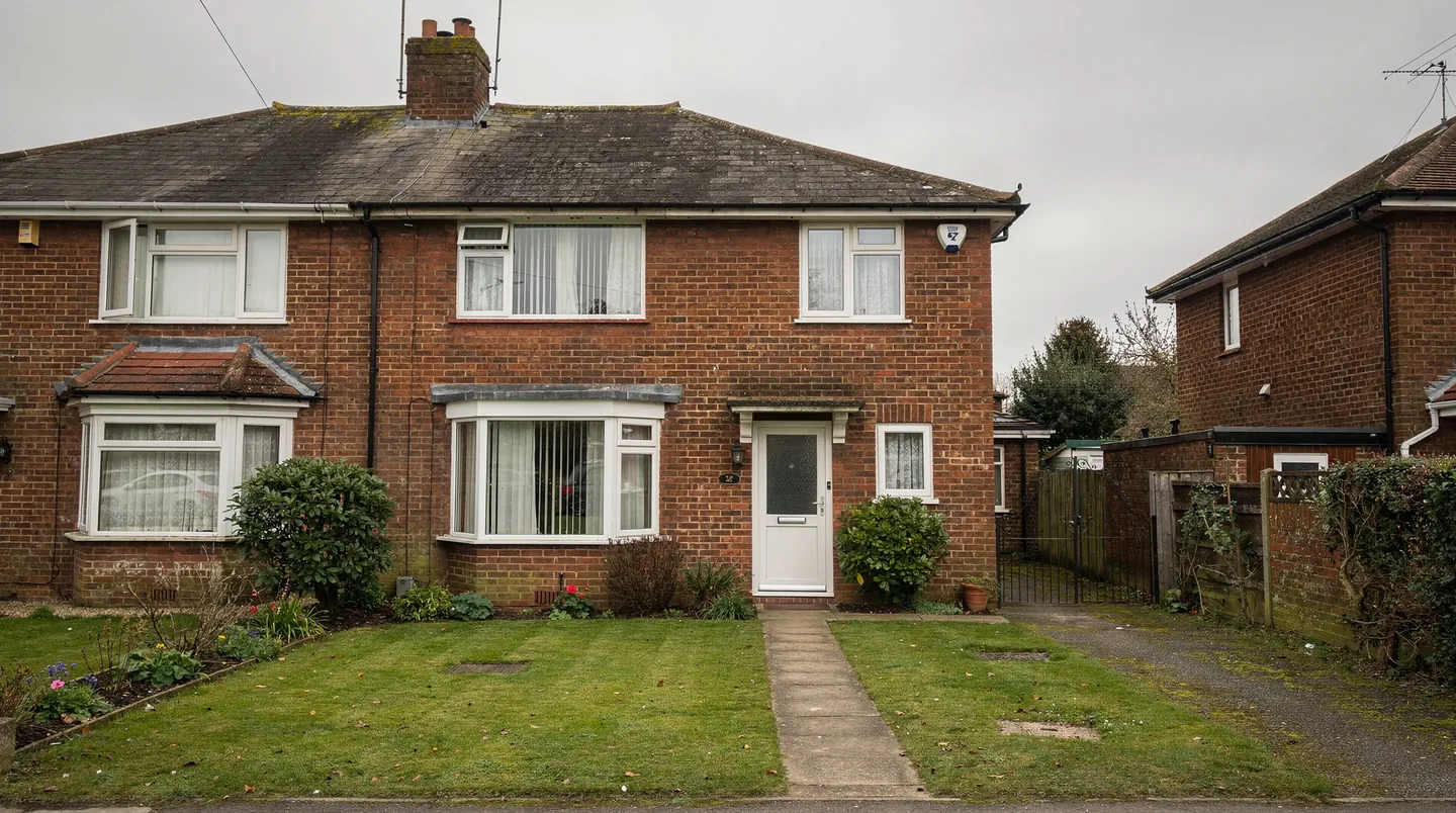 The front of a 1930s semi-detached house with a tiled roof