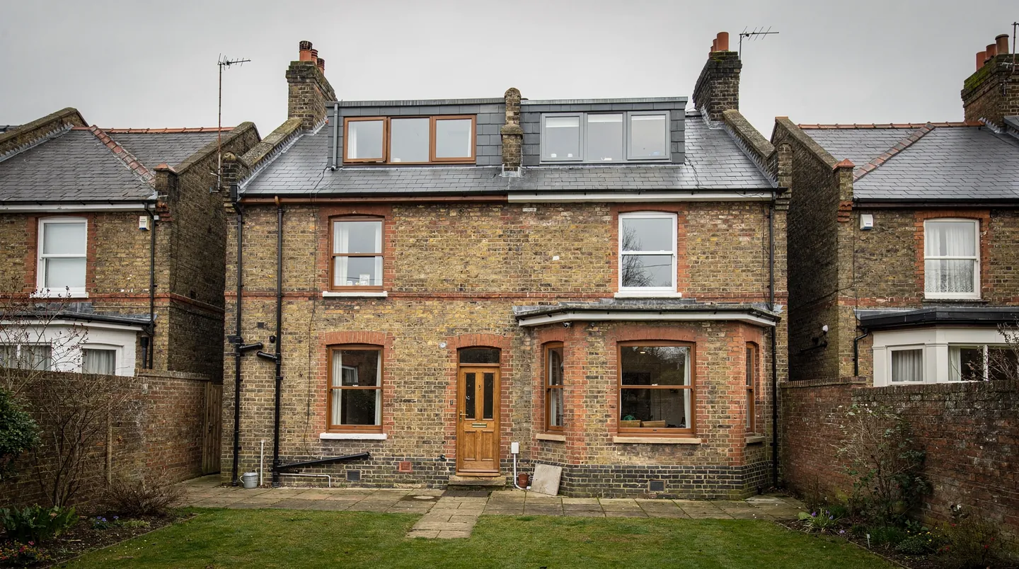 The back of an Edwardian house with a loft conversion set into the slate roof